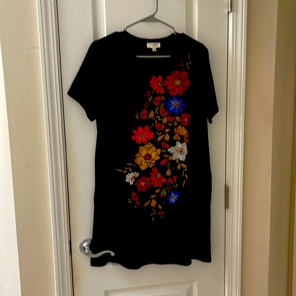 Black shift dress with floral embroidery.
